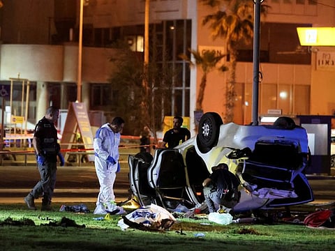 Israeli officials work at the scene of an attack in Tel Aviv April 7, 2023.  