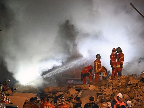 Rescue personnel work at the scene where a building collapsed in the southern French port city of Marseille  early on April 9, 2023. 