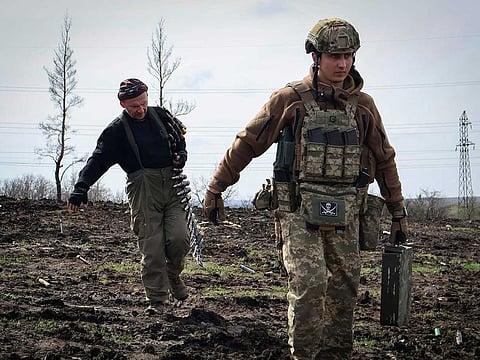 Ukrainian soldiers carry cartridges in their position on the frontline, near Bakhmut, Donetsk region, Ukraine, Friday, April 7, 2023. Newly leaked US intelligence documents offer tactical information about the war in Ukraine. 
