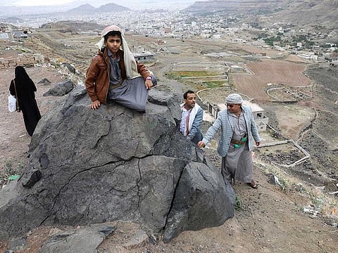 People enjoy the view from a hill overlooking Sanaa as Yemenis live the atmosphere of Ramadan while enjoying a relative calm, the longest stretch in an eight-year civil war, under a UN-brokered truce deal that lapsed in October but had largely held, in Sanaa, Yemen April 2, 2023. 