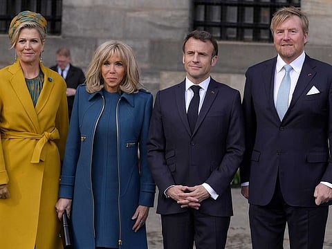 French President Emmanuel Macron, second right, his wife Brigitte Macron, second left, Dutch King Willem-Alexander and Queen Maxima,left, pose outside the royal palace on Dam square in Amsterdam, Netherlands, Tuesday, April 11, 2023.