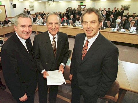 In this file photo taken on April 10, 1998, British Prime Minister Tony Blair (R), US Senator George Mitchell (C) and Irish Prime Minister Bertie Ahern pose for a photograph after signing an historic agreement -- The Good Friday Agreement -- for peace in Northern Ireland, ending a 30-year conflict. 