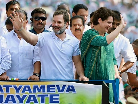 Congress leader and former Wayanad MP Rahul Gandhi along with party leader Priyanka Gandhi Vadra wave to the supporters during a roadshow, in Wayanad on Tuesday, April 11, 2023. 