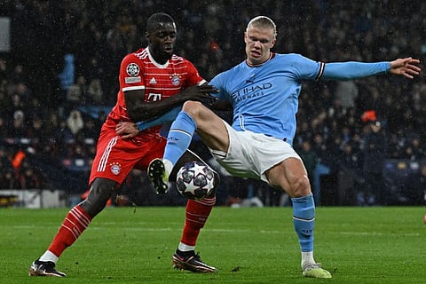Bayern Munich's French defender Dayot Upamecano (ledt) vies with Manchester City's Norwegian striker Erling Haaland during the UEFA Champions League quarter final, first leg at the Etihad Stadium in Manchester, north-west England.