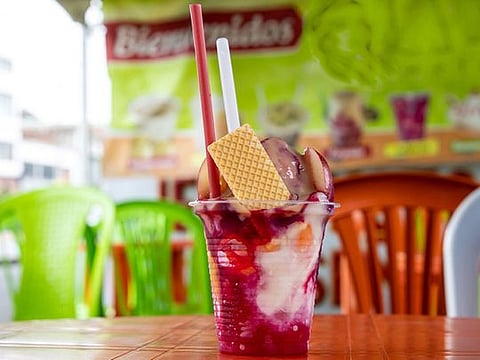 Colombian Cholado, an icy drink with fruit syrup and condensed milk
