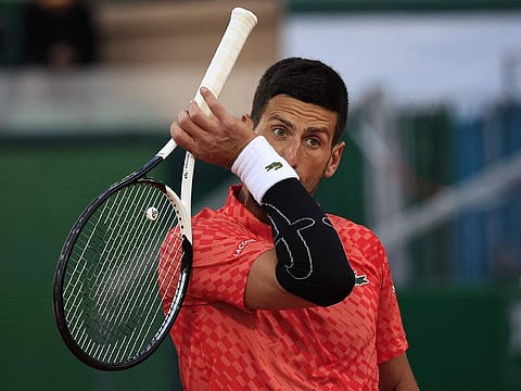 Serbia's Novak Djokovic reacts during his match against Italy's Lorenzo Musetti at the  Monte-Carlo ATP Masters Series tournament round of 16 tennis match in Monte Carlo on April 13, 2023. 