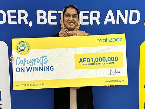 Indian mother Rinza stands for photograph after receiving her Dh1 million Mahzooz draw winning cheque.