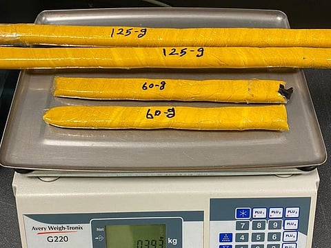 Four packages of heroin that were concealed in the parts of a suitcase.