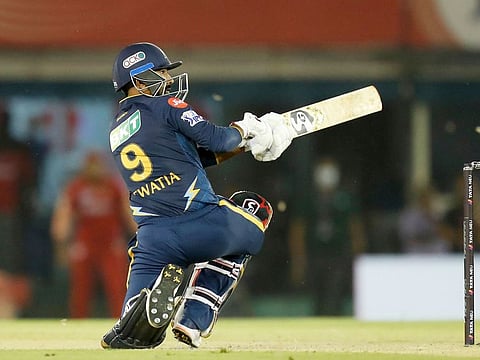 Rahul Tewatia of the Gujarat Titans scores the winning runs in the Tata Indian Premier League match against the Punjab Kings at the Punjab Cricket Association IS Bindra Stadium in Mohali on April 13, 2023. The boundary came when Gujarat needed four runs from two balls. 