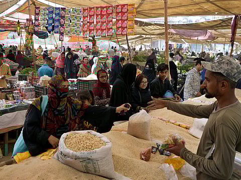 People shop at a bazaar setup by provincial government to provide items on discounted rates in Karachi in Ramadan.