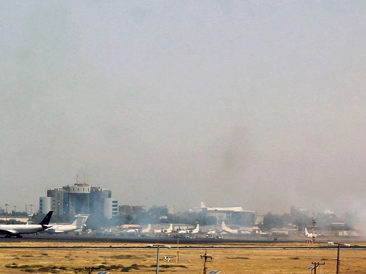 Smoke on the tarmac of the Khartoum airport on April 15, 2023, amid clashes in the Sudanese capital.  