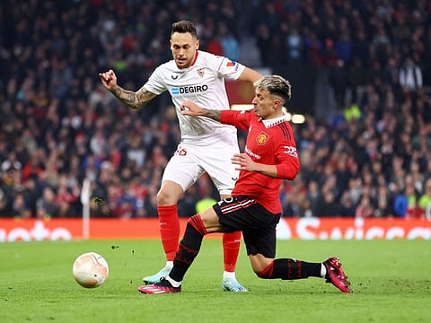 Manchester United's Lisandro Martinez (right) in action with Sevilla's Lucas Ocampos.
