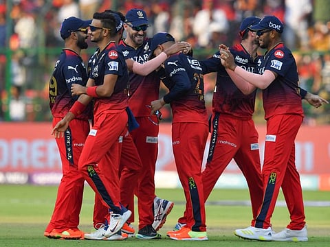 Royal Challengers Bangalore's players celebrate after beating Delhi Capitals in the Indian Premier League at the M Chinnaswamy Stadium in Bengaluru.