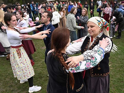 People dance during the Orthodox Easter celebrations in the western Ukrainian city of Lviv, on April 16, 2023. 