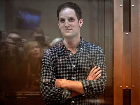 Wall Street Journal reporter Evan Gershkovich stands in a glass cage in a courtroom at the Moscow City Court, in Moscow, Russia, Tuesday, April 18, 2023.