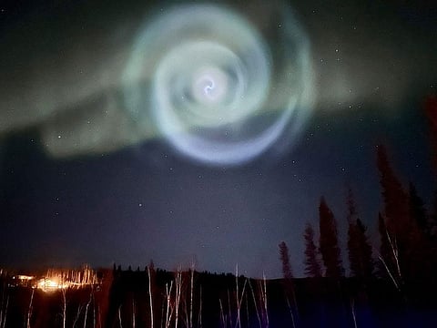 A light baby blue spiral resembling a galaxy appears amid the aurora for a few minutes in the Alaska skies near Fairbanks, Saturday, April 15, 2023.  