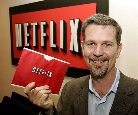 Reed Hastings, founder and CEO of Netflix, holds one of the envelopes used by Netflix to ship DVDs to members, at his office in Beverly Hills, California.