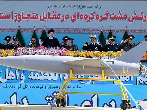 Iran's President Ebrahim Raisi watches combat drones alongside high-ranking officials and commanders during a military parade marking the country's annual army day in Tehran on April 18, 2023.  