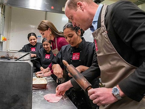 Britain's Catherine, Princess of Wales (3L) and Britain's Prince William, Prince of Wales (R) help in the kitchen during a visit to The Indian Streatery in Birmingham on April 20, 2023, to celebrate Birmingham's rich Asian culture.  