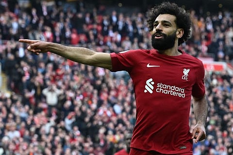 Liverpool's Egyptian striker Mohamed Salah celebrates after scoring their third goal during the English Premier League match against Nottingham Forest.