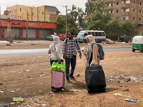 People gather as they flee clashes between the paramilitary Rapid Support Forces and the army in Khartoum.