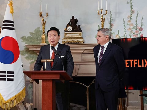 South Korean President Yoon Suk Yeol speaks next to Netflix co-CEO Ted Sarandos during a news conference in Washington, U.S.