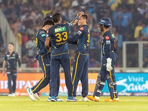 Gujarat Titans' Noor Ahmad celebrates a wicket of Mumbai Indians with teammates during their match in Ahmedabad on Tuesday.