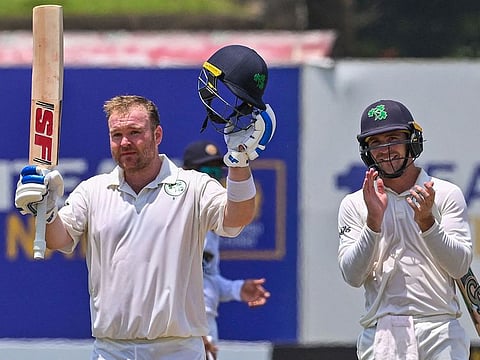 Ireland's Paul Stirling celebrates after scoring his Curtis Campher, the other centurion, applauses during the second day of the second and final Test against Sri Lanka.