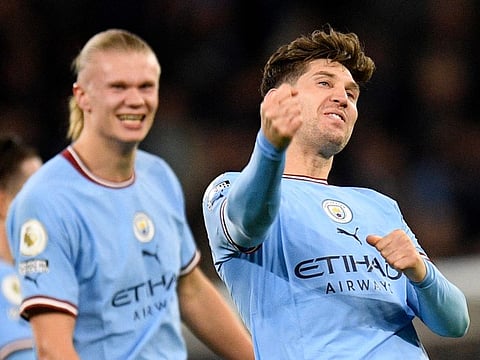 Manchester City defender John Stones (right) celebrates after scoring the team's second goal with Erling Haaland during the English Premier League match against Arsenal at Etihad Stadium on Wednesday.