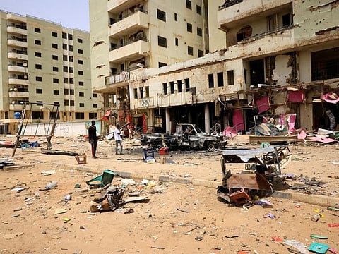 Damaged cars and buildings at the central market after clashes between the paramilitary Rapid Support Forces and the army in Khartoum North, on April 27, 2023.  