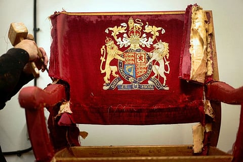 An upholsterer works on restoring a throne chair at Marlborough House, ahead of the Coronation of King Charles and Camilla, Queen Consort on May 6., in London, Britain February 17, 2023.