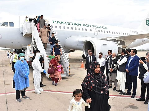 Pakistanis evacuated from Sudan arriving at Karachi airport on April 28, 2023.   
