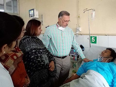 Punjab Health Minister Balbir Singh meets a person who was injured in the gas leak incident, at Civil Hospital Ludhiana, in Ludhiana on Sunday, April 30, 2023.