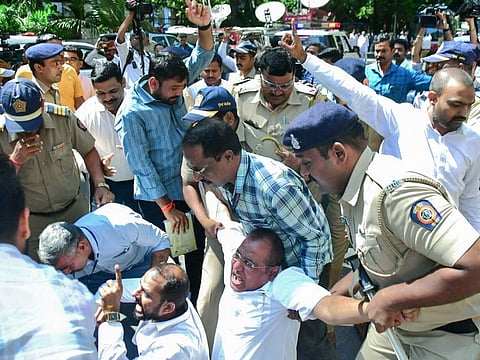 Police detain Nationalist Congress Party (NCP) supporters during the protest against the decision of Sharad Pawar to resign from his position as party president, in Mumbai on Tuesday, May 2, 2023.