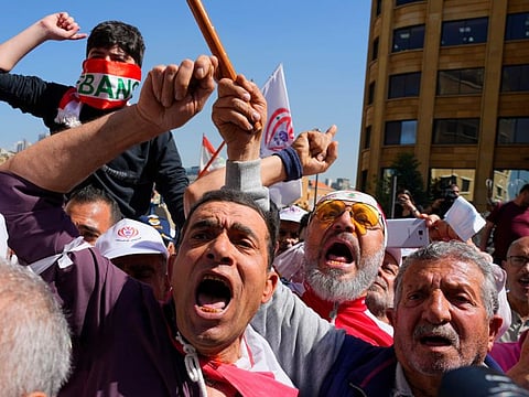 Retired members of the Lebanese security forces and other protesters, shout slogans during a protest demanding better pay and living conditions in Beirut.