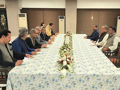 Representatives of the ruling Pakistan Democratic Movement (PDM) and ex-PM Imran Khan’s PTI party hold talks to reach a consensus on elections, in Islamabad on May 2, 2023. 