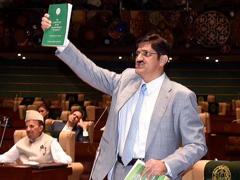 Sindh Chief Minister, Syed Murad Ali Shah, shows a copy of the Constitution while speaking in Sindh Assembly. 