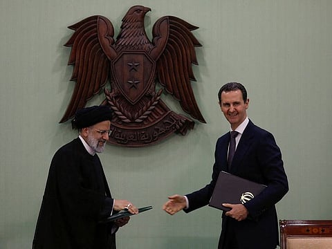 Syria's President Bashar Al Assad and Iranian President Ebrahim Raisi during the signing of cooperation agreement in Damascus on May 3, 2023.  