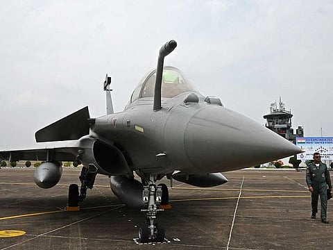 An Indian Air Force (IAF) personnel walks past a Rafale fighter jet during the joint 'Exercise Cope India 2023' between the United States Air Force (USAF) and IAF at the air force station in Kalaikunda, in India's West Bengal state on April 24, 2023.