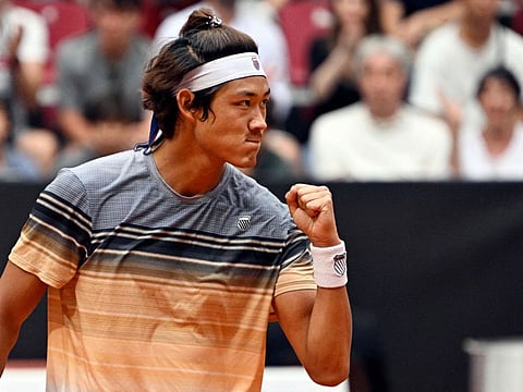 China's Zhang Zhizhen celebrates after winning a point against Taylor Fritz in Madrid Open on Tuesday.