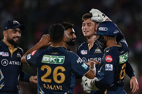 Gujarat Titans' Noor Ahmad (second from right) celebrates with teammates after dismissing Rajasthan Royals' Devdutt Padikkal.