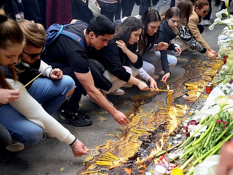 School children light candles near the Vladislav Ribnikar school in Belgrade. Many wearing black and carrying flowers, scores of Serbian students on Thursday paid silent homage to their peers killed a day earlier when a 13-year-old boy used his father’s guns in a school shooting rampage that sent shock waves through the nation and triggered moves to boost gun control.  