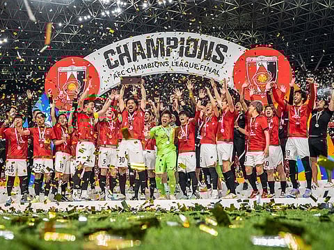 Urawa Red Diamonds players celebrate with the trophy after their victory against Al Hilal in the second leg of the AFC Champions League final at Saitama Stadium in Saitama on May 6, 2023. 