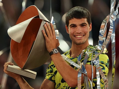 Spain's Carlos Alcaraz holds the trophy after winning the Madrid Open at Caja Magica in Madrid on Sunday.