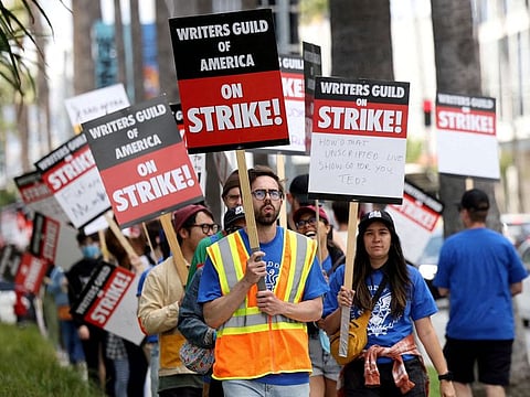 Writers Guild of America members and supporters picket outside Sunset Bronson Studios and Netflix Studios, after union negotiators called a strike for film and television writers, in Los Angeles, California, US, on May 3, 2023. The negotiations centred around how much writers should be compensated for their work on films, TV shows and streaming series. 