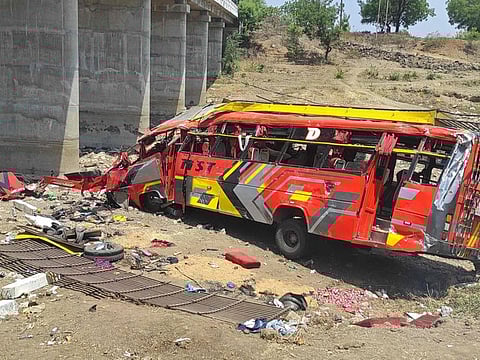 Onlookers gather at the site of a bus accident in Khargone district of India's Madhya Pradesh state on May 9, 2023.  