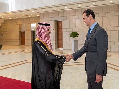 Syrian President Bashar Al Assad, right, welcomes Saudi Minster of Foreign Affairs Faisal bin Farhan, before their meeting in Damascus, on April 18, 2023. 