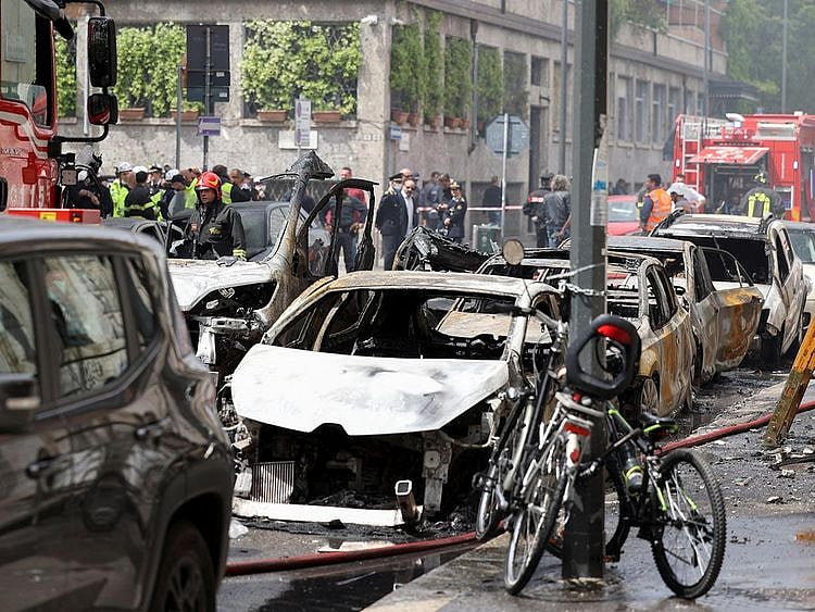 Firefighters work at the site of an explosion in the centre of Milan