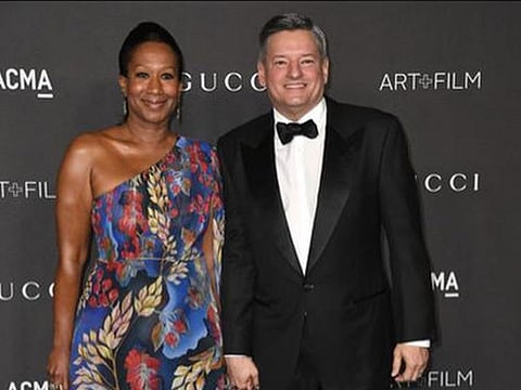 Netflix CEO Ted Sarandos (R) with wife Nicole Savant