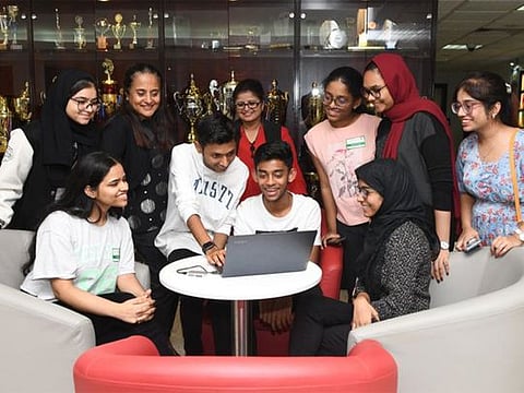 Ishika Khandelwal (seated left), who scored 98.6 per cent, and other Grade 12 students of OIS as they discuss their results. 